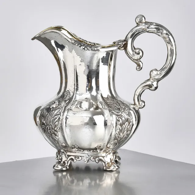 KANNA, silver, av Gustaf Folcker, Stockholm 1847, livet med punsad och graverad dekor av blommor, invändigt förgylld, nyrokoko.