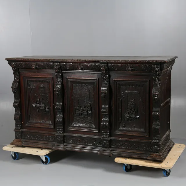A VICTORIAN CARVED OAK SIDEBOARD.