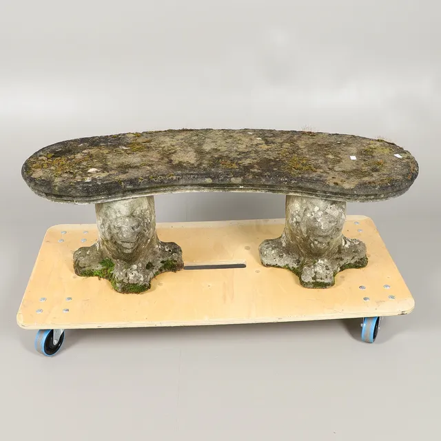 A CURVED COMPOSITE STONE BENCH.