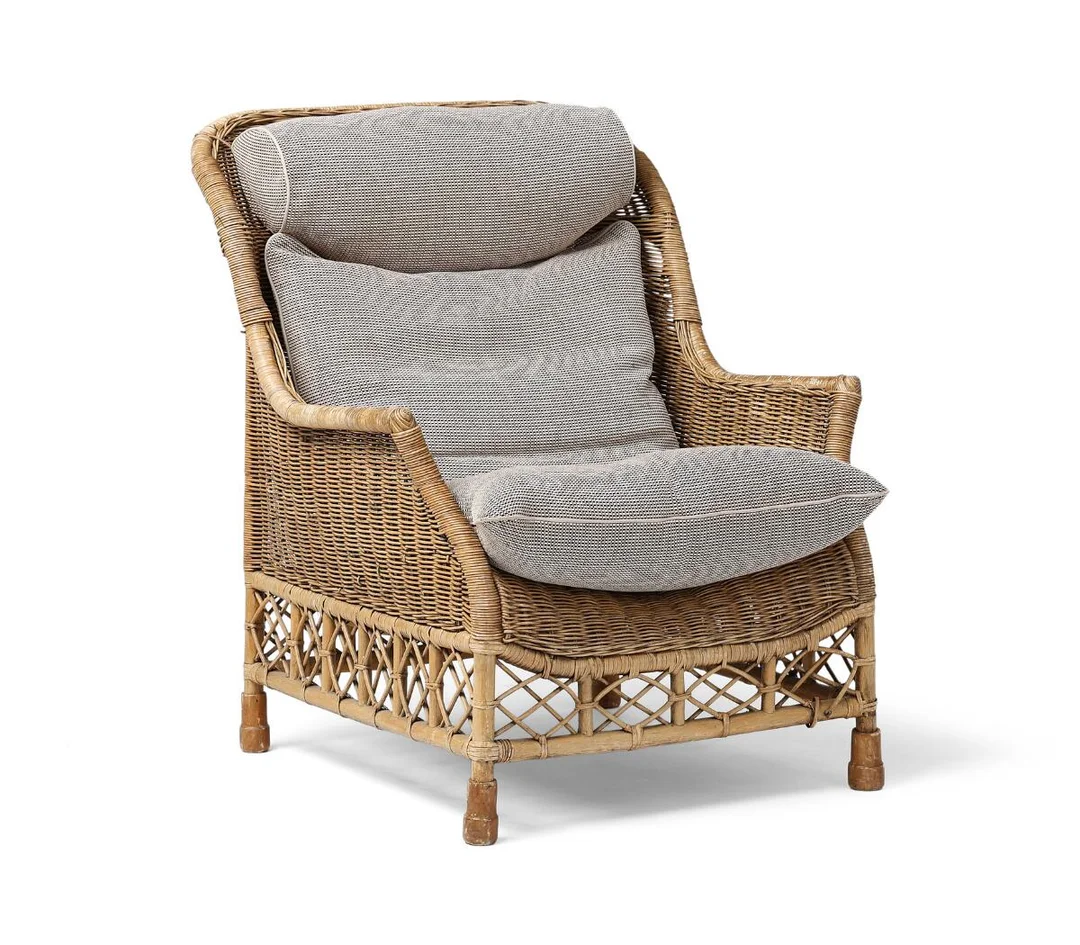 “Karen Blixen”. A woven rattan lounge chair. Loose cushions upholstered with grey fabric. Manufactured by Søren Lund Møbler. — Modern Furniture — Bruun Rasmussen