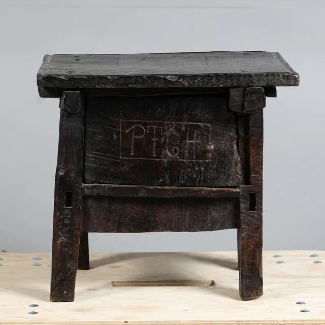 A 17TH CENTURY STYLE OAK DATED STOOL.