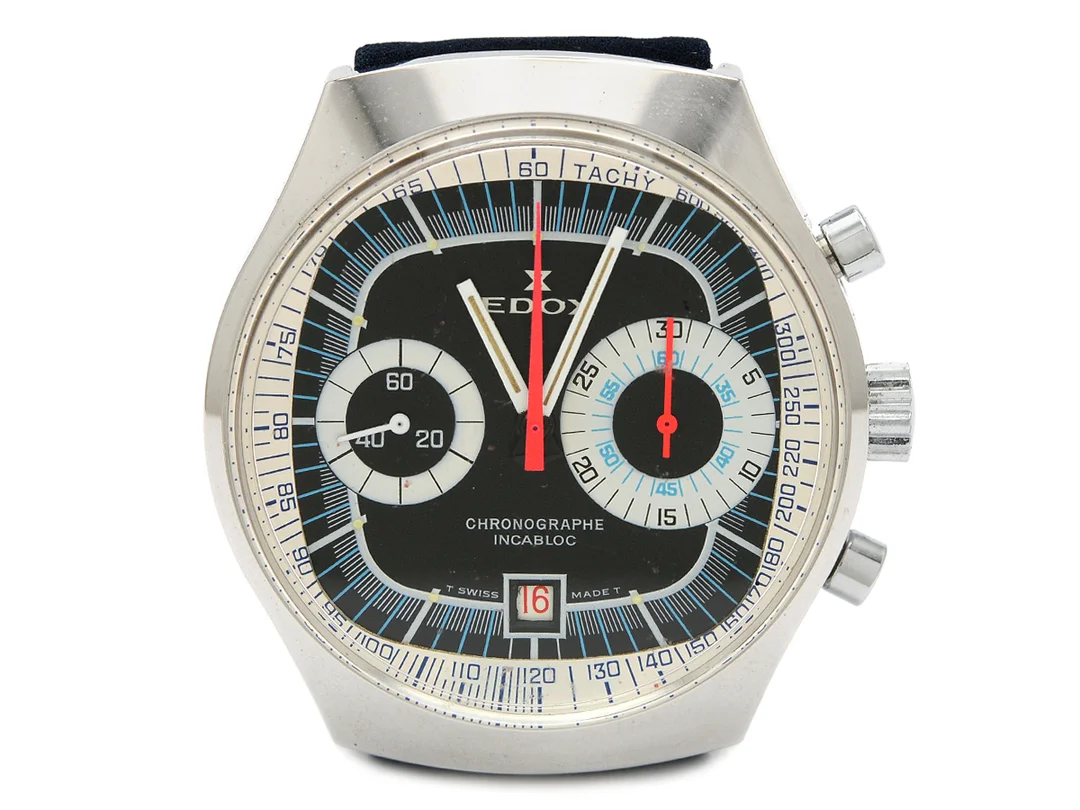 EDOX, kronograf, "Tachy", Cal Valjoux 7734, Boett nr. 6000, herrur, 40 mm, vitmetall, manuell, plexiglas, datum, läderband, originalspänne, hängetikett, ca 1970. — Klockor/Edox — Kaplans