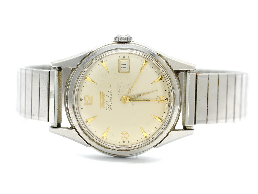 TISSOT, Visodate, Cal 27 B-621, Serie nr. 3257048, Ref nr. 6606, Boett nr. 6606.1, herrur, 35 mm, stål, manuell, plexiglas, datum (roulette), skadad urtavla, ca 1953, metallänk ej original. — Klockor/Tissot — Kaplans