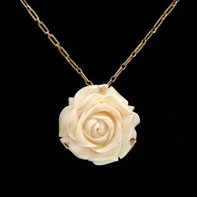 Rose-shaped brooch-pendant.