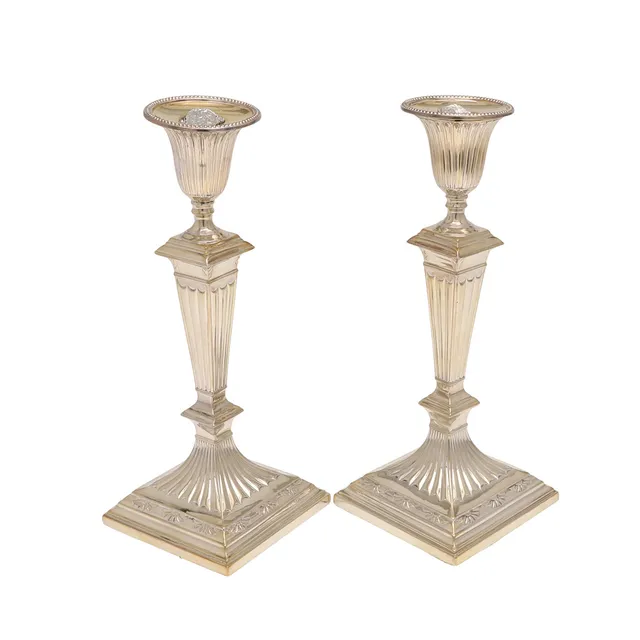 A PAIR OF LOADED VICTORIAN SILVER CANDLESTICKS.