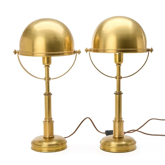 “Carthage”. A pair of brass table lamps with adjustable shade. Retailed by Visual Comfort & Co. marked with label. H. 60 cm. (2)