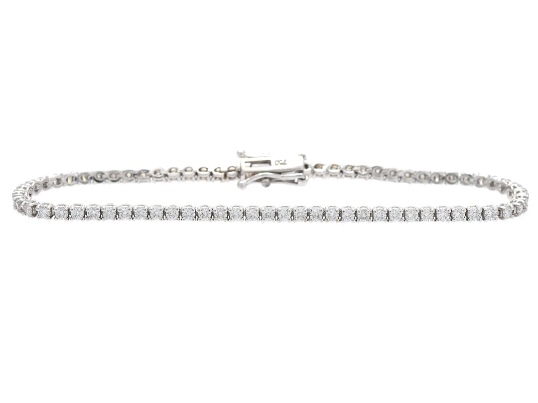TENNISARMBAND, 18K vitguld, 71 briljantslipade diamanter ca 2,01 ct, ca TW-W/VS-SI, längd 16,5 cm, vikt 6,4 g. — Smycken/Armband — Kaplans