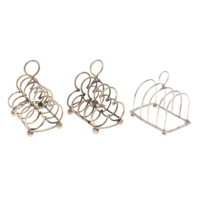 A PAIR OF EDWARDIAN SILVER FOUR PLACE TOAST RACKS AND ANOTHER.