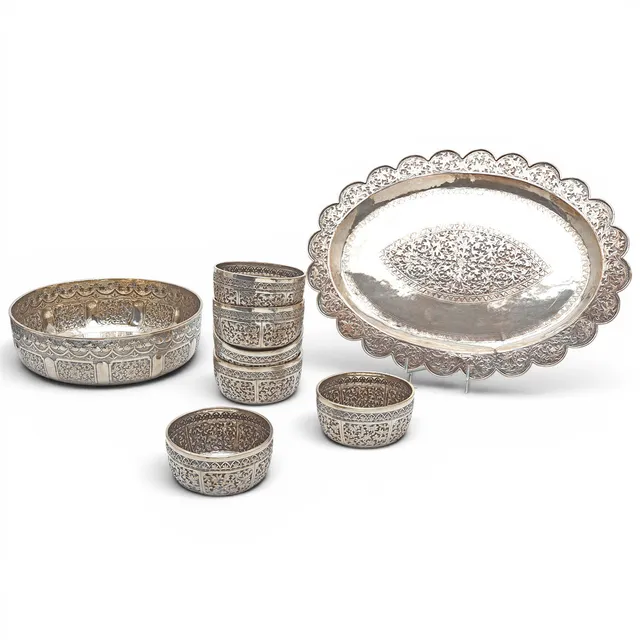 PROBABLY Indian silver-plated metal service set with embossed decoration, third quarter of the 20th century.