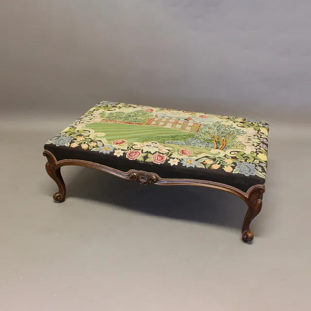 A WALNUT NEEDLEWORK FOOTSTOOL.