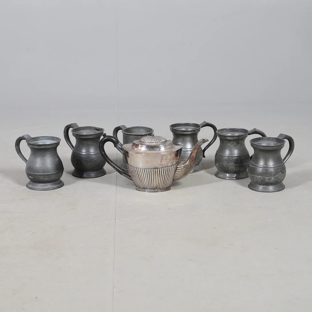 A QUANTITY OF PEWTER TANKARDS AND A SILVER PLATED TEA POT. — Pewter, Brass & Copper — Lawrences Auctioneers