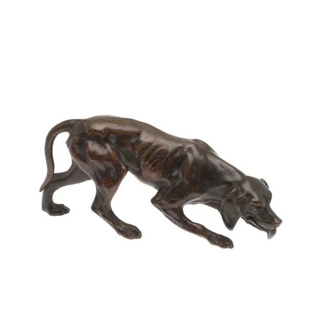 A CONTINENTAL PATINATED BRONZE OF A HUNTING DOG.