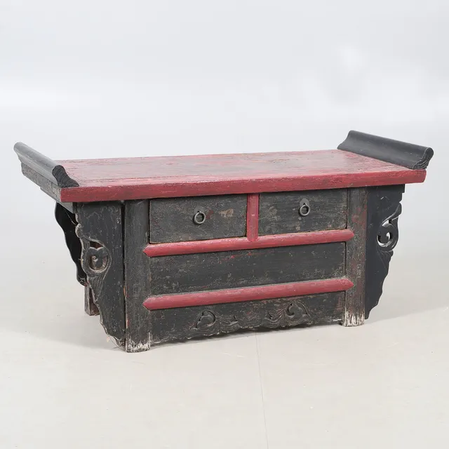 A CHINESE LOW STAINED RED TABLE AND DRAWERS.