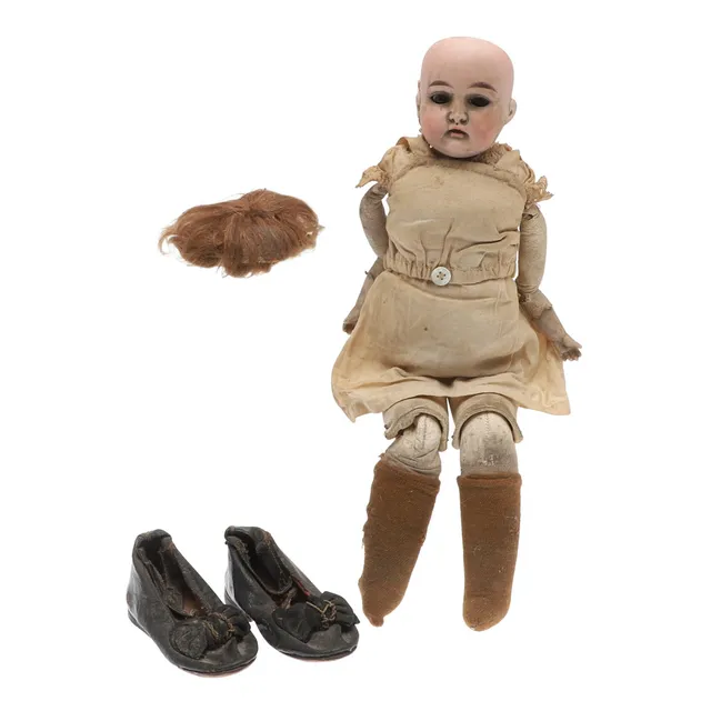 A VICTORIAN BISQUE-HEAD DOLL BY CUNO & OTTO DRESSEL.