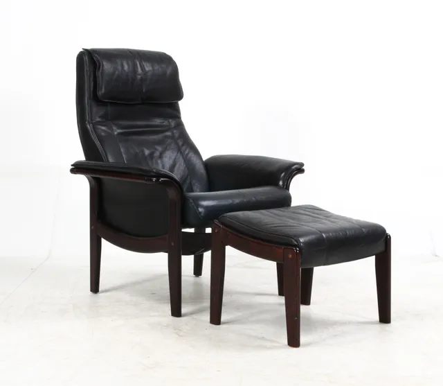 Furniture manufacturer. Armchair with stool, black leather (2)