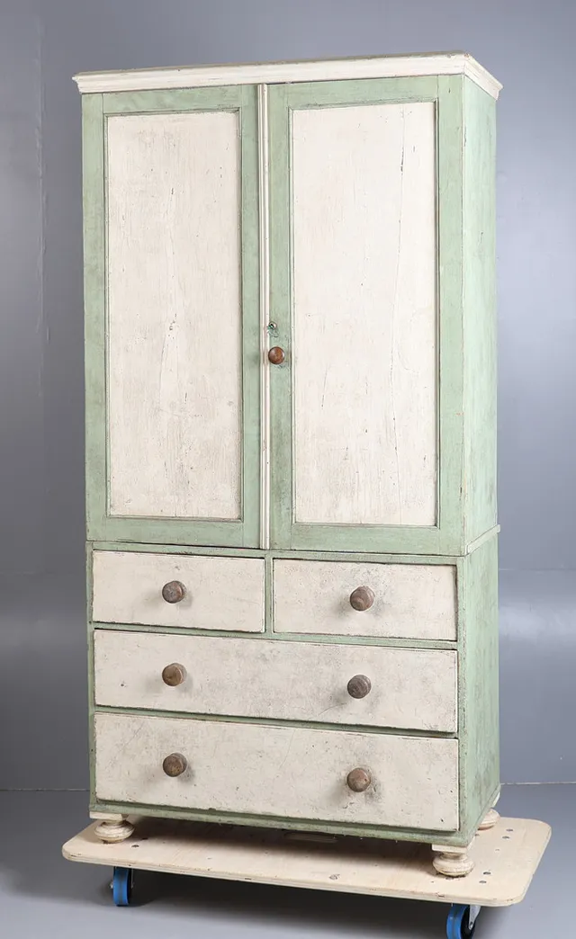 A 19TH CENTURY PAINTED PINE LINEN CUPBOARD ON CHEST.