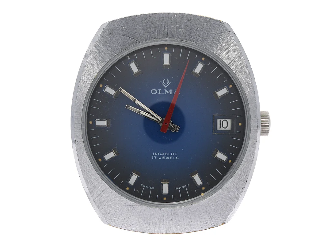 OLMA, herrur, 35 x 41,5 mm, Boett nr. 35558-3 / 173, vitmetall, manuell, datum, plexiglas, skadad urtavla, ca 1970. — Klockor/Olma — Kaplans