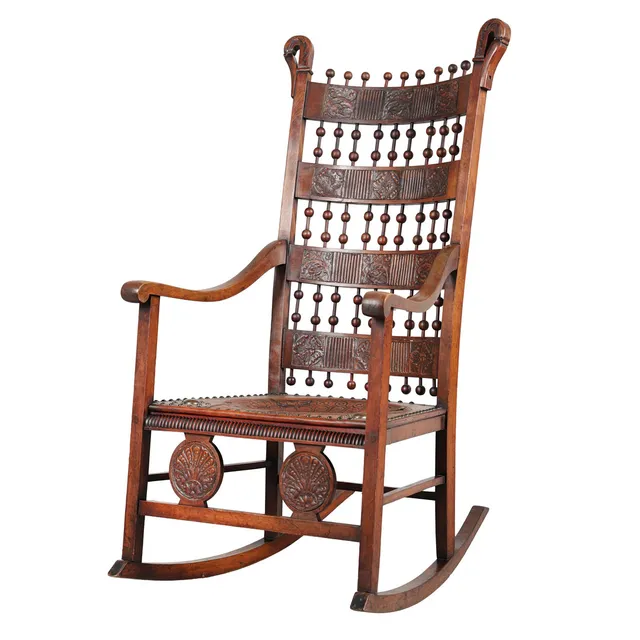 A LATE 19TH CENTURY ROCKING CHAIR IN THE MOORISH STYLE POSSIBLY BY CARLO BUGATTI, CIRCA 1890.