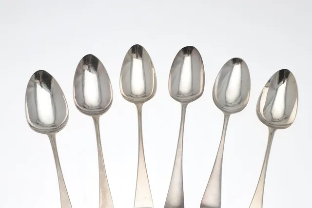 SIX GEORGE III SILVER OLD ENGLISH PATTERN TABLE SPOONS.