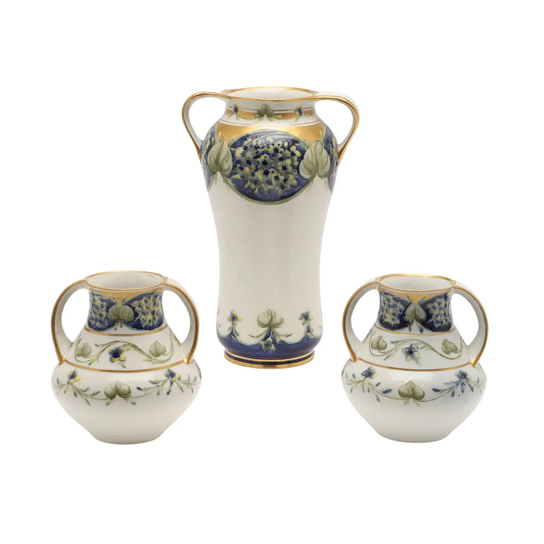 WILLIAM MOORCROFT - MACINTYRE FLORIAN VASE & PAIR OF VASES - LILAC. — European — Lawrences Auctioneers