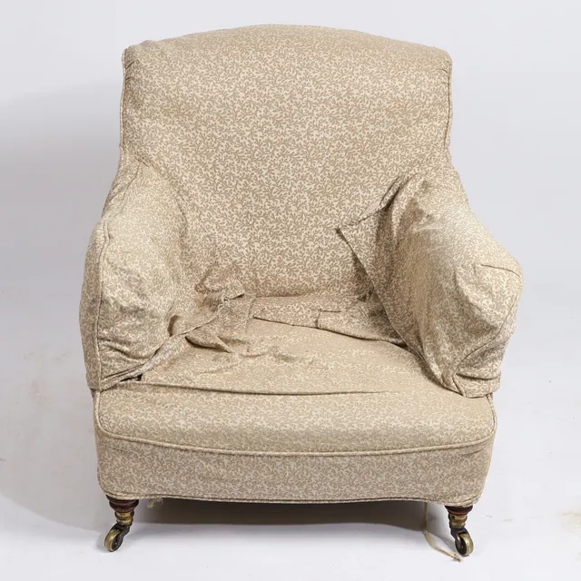 HOWARD & SONS LTD. A DEEP SEATED ARMCHAIR.