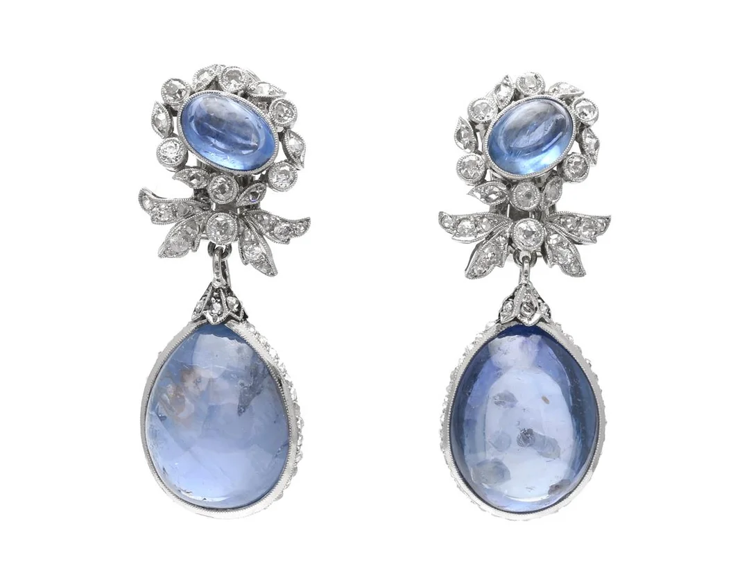 ÖRHÄNGEN, med påhängen, platina, troligen obehandlade safirer ca 40,00 ctv, gammal- och rosenslipade diamanter ca 0,80 ctv, tidigt 1900-tal, höjd 38 mm, vikt 18,3 g, senare stift med clips i 18K vitguld av Erik Thomassons Guld & Juvelfirma, Stockholm 1953, tre små rosenslipade diamanter saknas, flera diamanter har nagg och skador, en av de stora safirena har inneslutningar som når ytan, etui. — Smycken/Örhängen — Kaplans