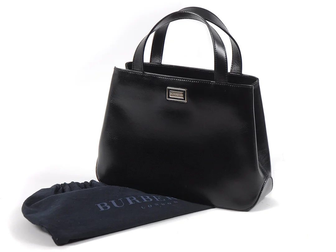 VÄSKA, BURBERRY svart läder/rutigt tyg foder 37x19x8 cm dustbag — Accessoarer/Väskor — Kaplans