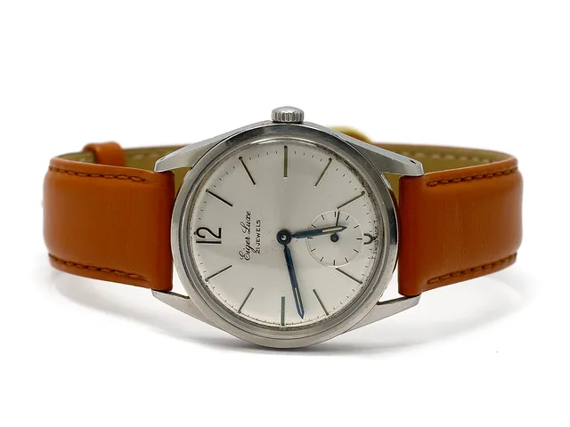 EIGER LUXE, herrur, 34 mm, Boett nr. 103250, vitmetall, manuell, plexiglas, liten sekundvisare, skadad urtavla, defekt, skadad boett, läderband, ca 1958.
