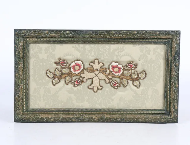 A 19TH CENTURY SILK AND WOOLWORK FLOWER SRPIG ON PANAL.