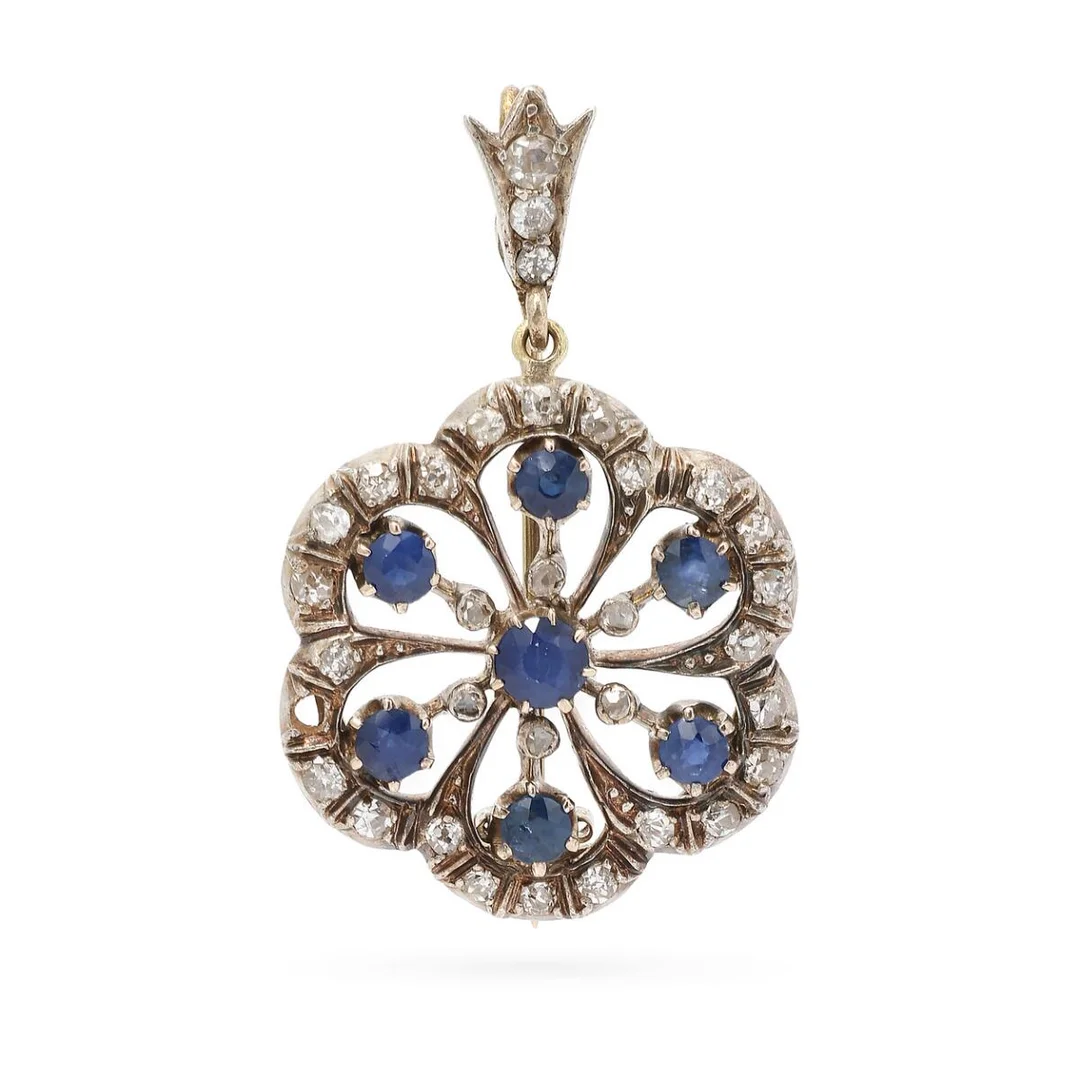 A sapphire and diamond brooch/pendant set with numerous circular-cut sapphires and rose-cut and old-cut diamonds, mounted in 8k gold and silver. Weight app. 7.3 g. W. 22 mm. L. 3.7 cm. — Jewellery/Brooches — Bruun Rasmussen
