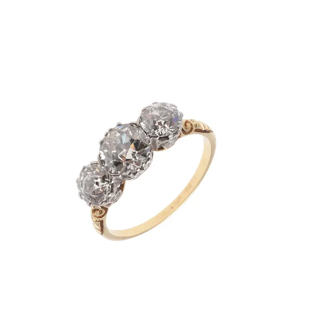 A DIAMOND THREE STONE RING.