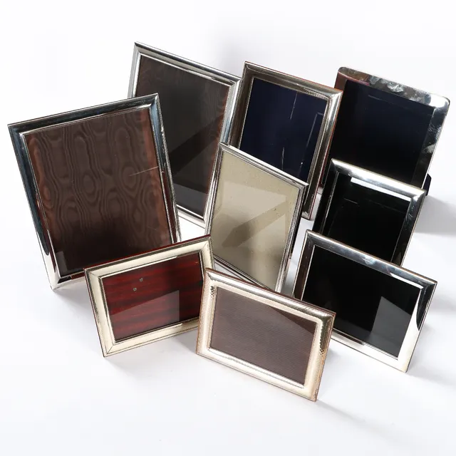 A collection of sterling silver and silver-plated metal photo frames. (9)