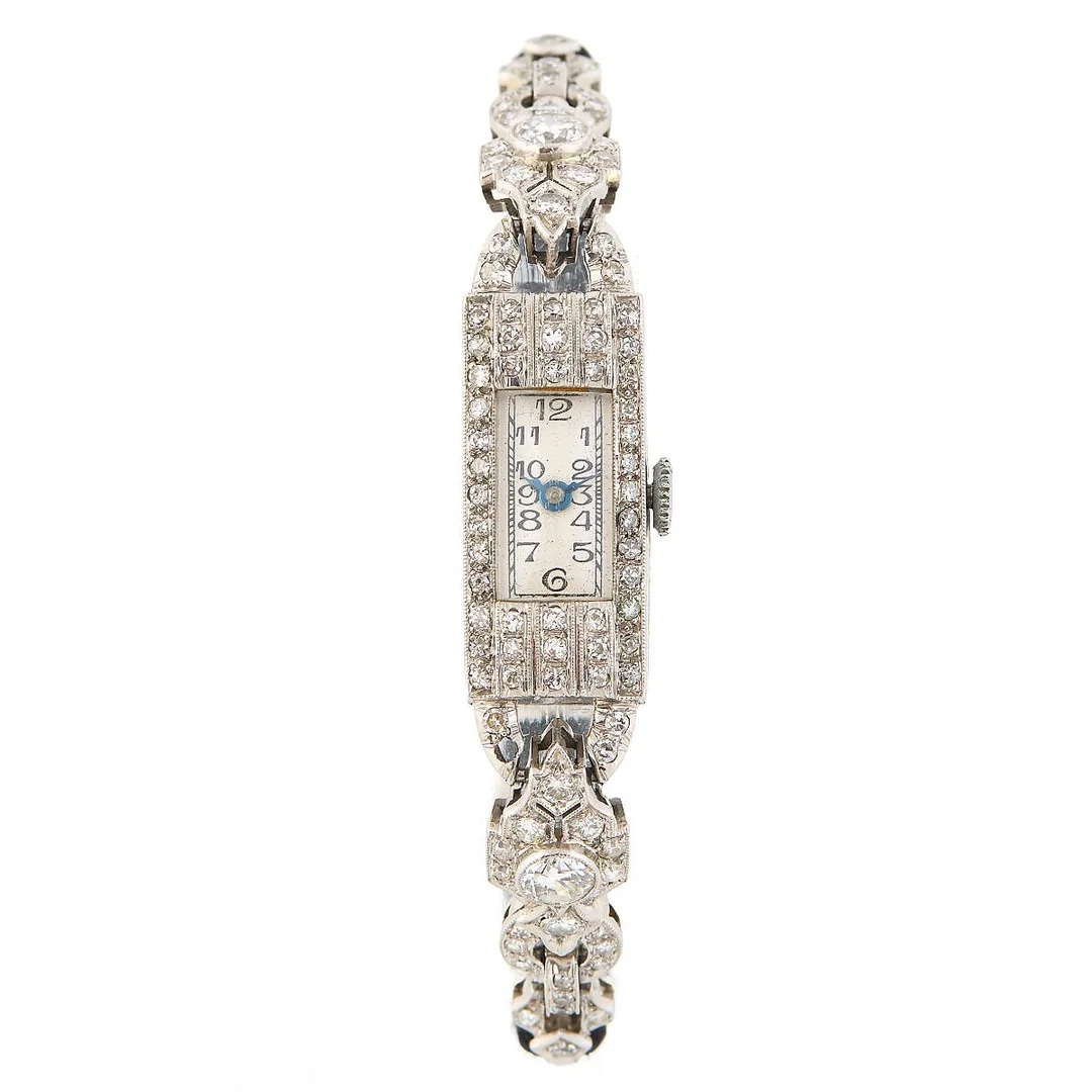 “Art Deco” of platinum. Mechanical movement with manual winding and diamond-set bezel and bracelet. Black fabric strap with lol fold-over clasp of steel. Circumference approximately 15.5 cm. 11×31 mm. 1930s. — Clocks & watches/Wristwatches — Bruun Rasmussen