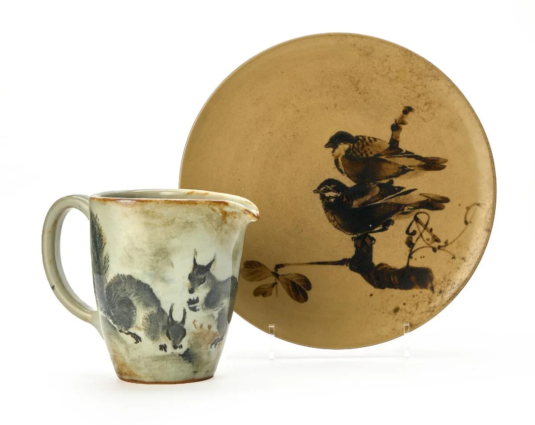 Stoneware dish and pitcher, decorated with resp. sparrow and squirrel. Signed monogram. Manufactured and marked by Kgl. P. Unique. Pitcher: H. 12.5 cm. L. 16 cm. Dish: H. 1.5 cm. Diam. 23 cm. (2) — Modern Decorative Art — Bruun Rasmussen