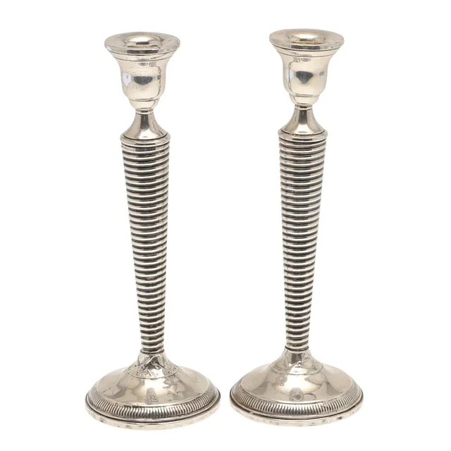 A PAIR OF WEIGHTED SILVER CANDLESTICKS.