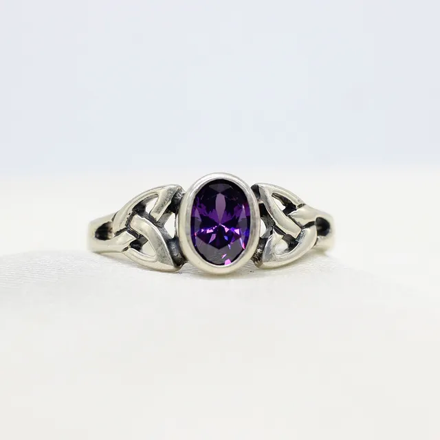 SILVER CELTIC RING WITH PURPLE CUBIC ZIRCONIA.