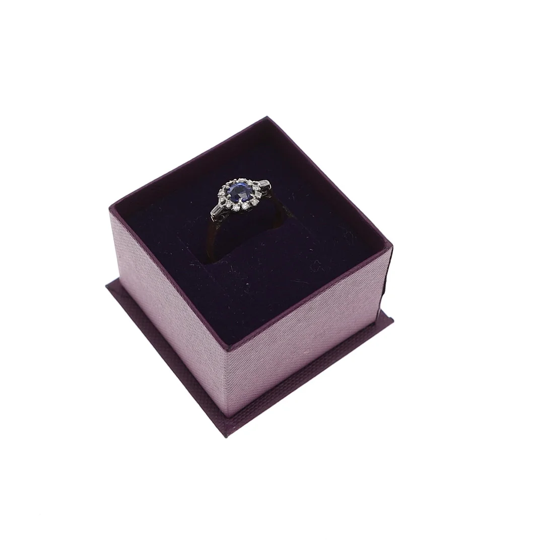 AN 18CT GOLD, DIAMOND AND SYNTHETIC SAPPHIRE CLUSTER RING. — Rings — Lawrences Auctioneers