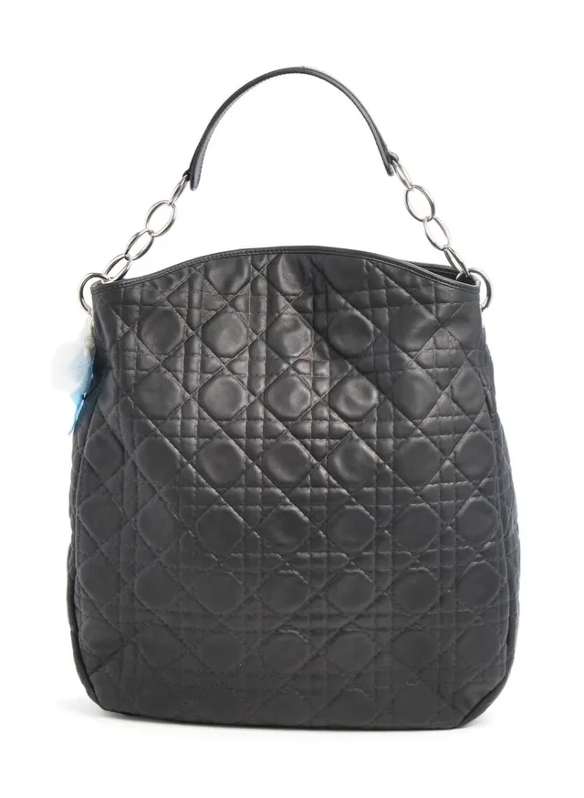 A “Hobo” bag of black cannage quilted lamb skin with silver tone hardware, short handle, one compartment with a magnetic closure, two interior pockets, one of which has a zipper, and black leather lining. H. 42 x W. 35 x D. 9 cm. 2008.