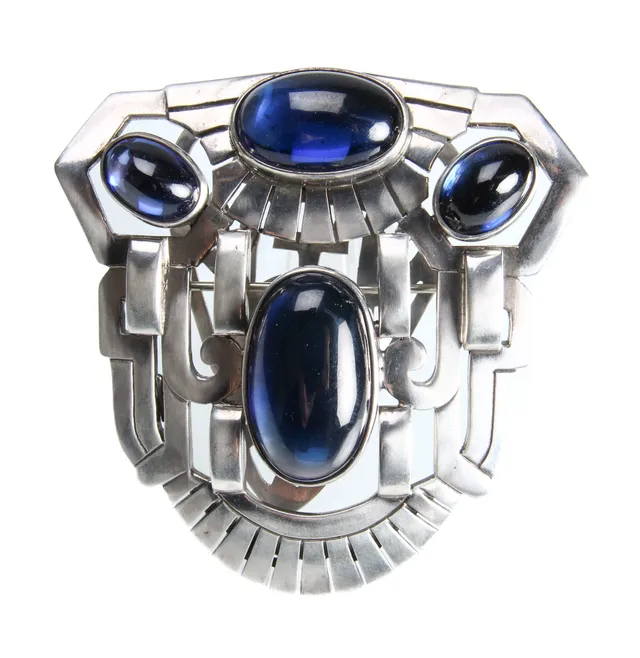 Heavy openwork platinum brooch with synthetic sapphires