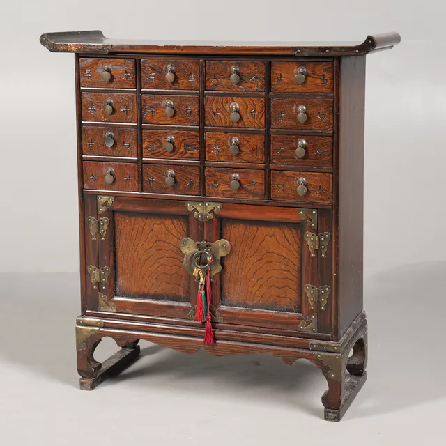 A CHINESE ELM APOTHECARY CABINET.