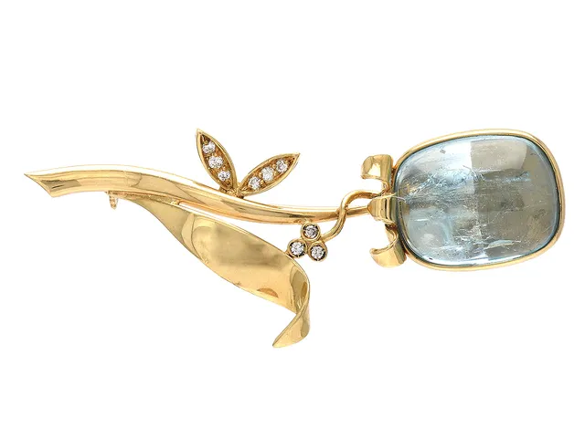 BROSCH, 18K guld, cabochonslipad akvamarin ca 19 x 15 mm, 9 briljantslipade diamanter ca 0,12 ctv, ca W/SI, höjd 65 mm, vikt 16 g.