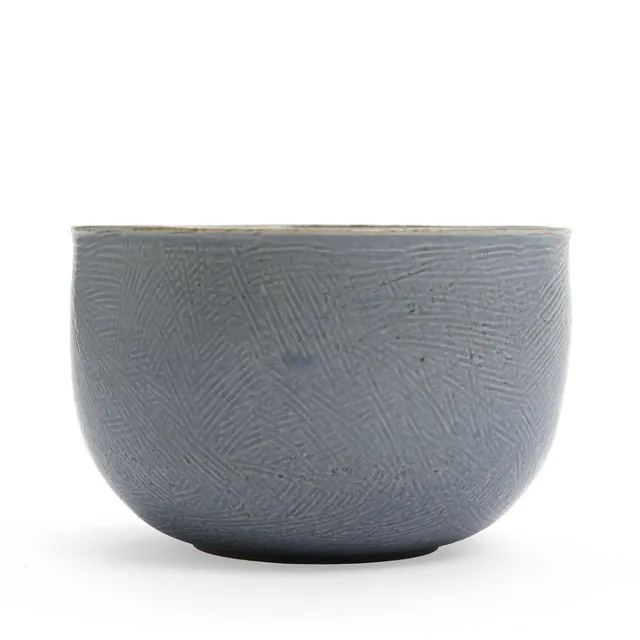 Deep bowl of stoneware modelled with straight sides. Decorated with light blue glaze over comb pattern. Signed monogram for Marie Hjorth and BM Hjorth. Manufactured by Hjorth, Bornholm. H. 11. Diam. 16.5 cm.
