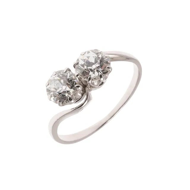 A DIAMOND TWO STONE CROSS-OVER RING.