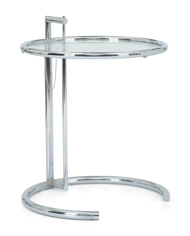 Side table with tubular chromed steel frame and circular clear glass top. Model E1027. Designed 1927. Manufactured and marked by ClassiCon. Height-adjustable. H. 55–93 cm. Diam. 51 cm.