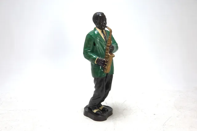 Figure of painted art material in the shape of a saxophone player, 21st century