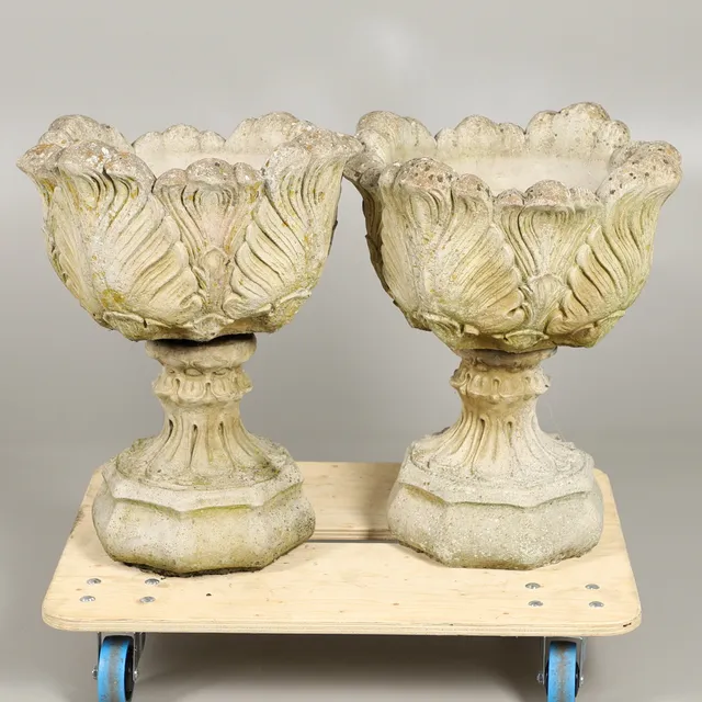 A PAIR OF RECONSTITUTED STONE ACANTHUS LEAF DECORATIVE URN PLANTERS.