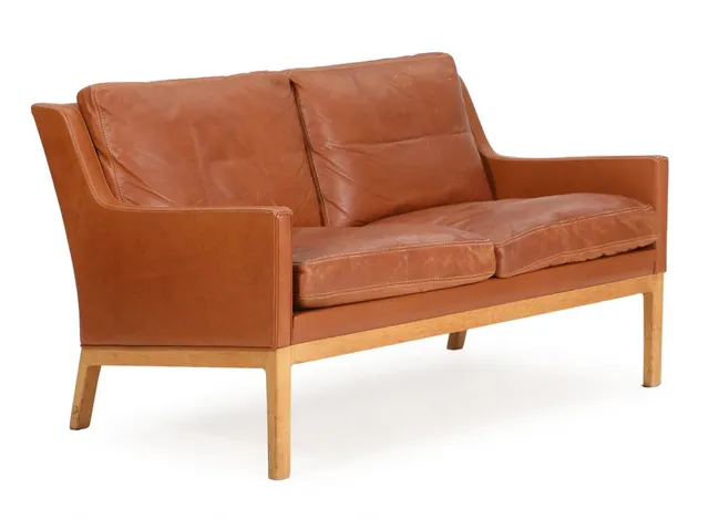 Freestandingt two seater sofa with oak frame, sides, back and loose cushions upholstered with brown leather. Model SW 39. Manufactured by Søren Willadsen. L. 130 cm.