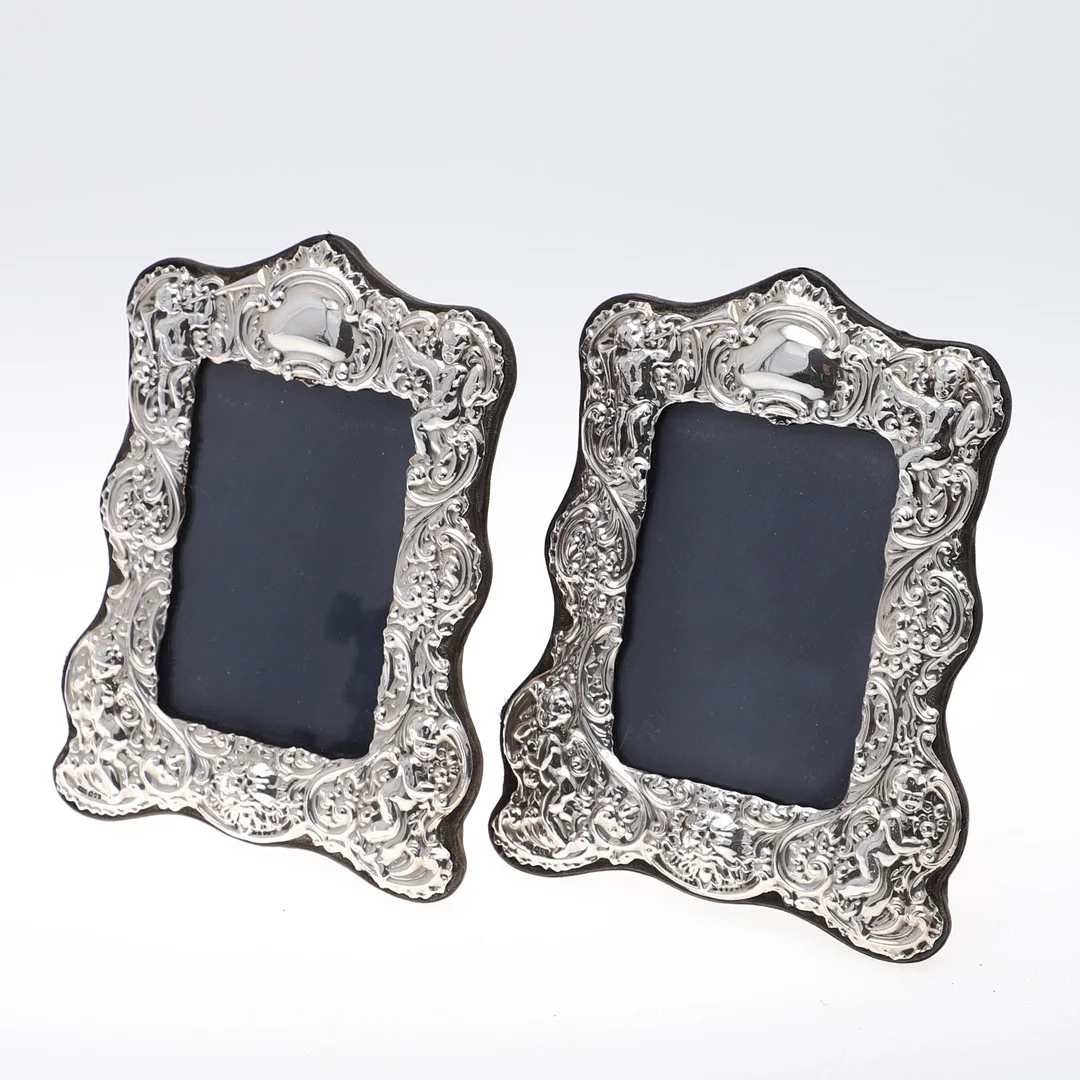 A PAIR OF ELIZABETH II MOUNTED PHTOGRAPH FRAMES. — Silver — Lawrences Auctioneers