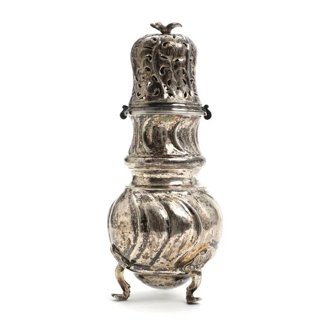 A Danish Rococo fluted silver caster of baluster form, pierced lid with finial in the form of a bird, standing on three cabriole legs with leaf ornaments. Master Andreas Krag, trade licence Næstved 1759. Weight approx. 198 g. H. 16.5 cm.