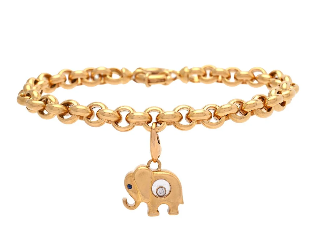 CHOPARD, Happy Diamond, armband med elefantberlock, 18K guld, safir, briljantslipad diamant 0,05 ct, refnr. 85/2478, serienr. 9263349 samt refnr. 80/2482-20, serienr. 9226428, längd 20 cm, vikt 23,8 g, visst slitage, originaletui. — Smycken/Armband — Kaplans